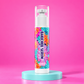 wHiPi. Beautiful Girl Bakuchiol Serum, 2 fl oz bottle with floral label on a pink background and aqua platform.