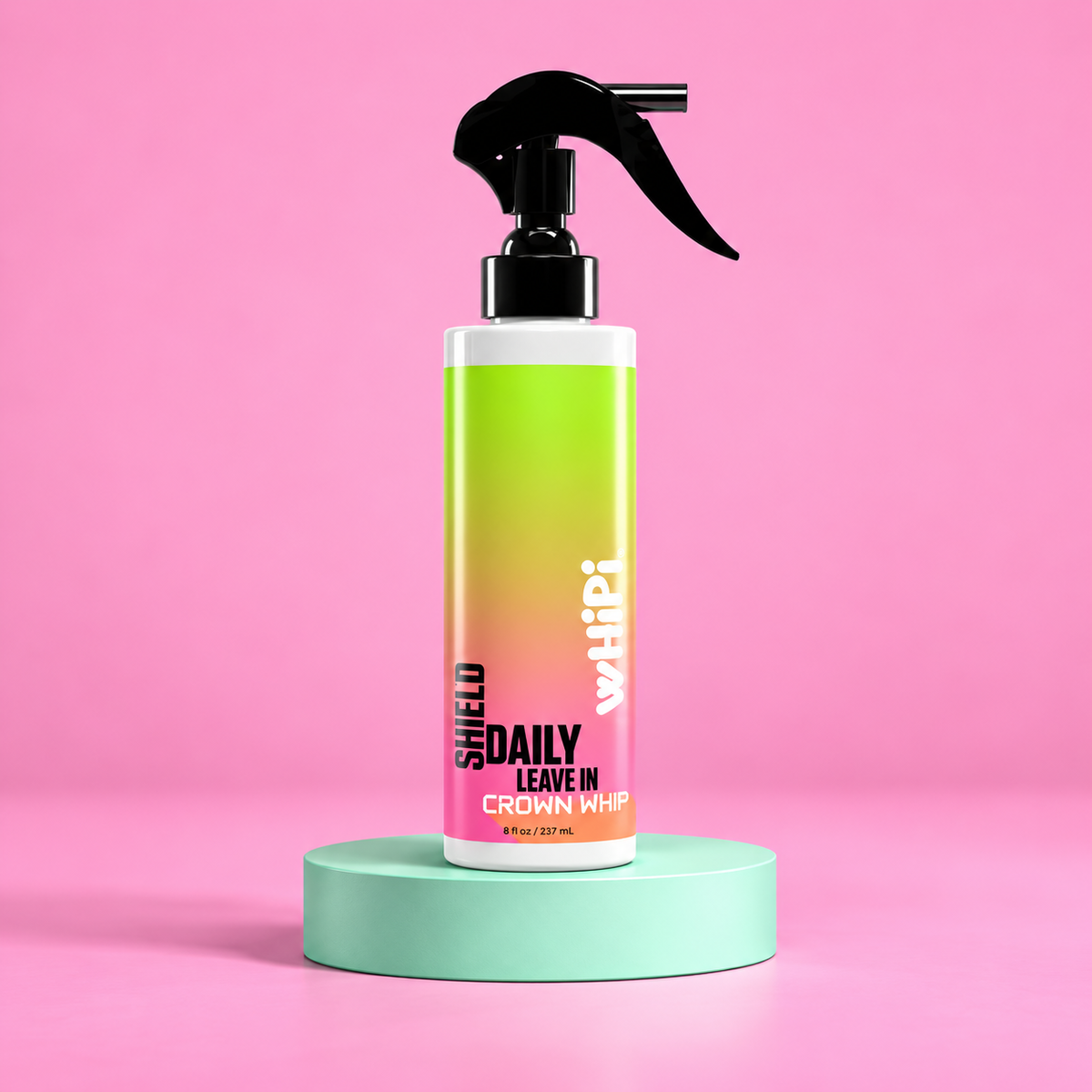 Crown Whip Shield 8 oz leave-in mist with black trigger on a mint pedestal against pink.